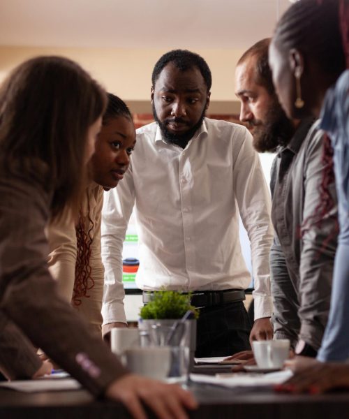 multi-ethnic-entrepreneurs-stand-up-analyzing-financial-graph-brainstorming-ideas-partnership-project-working-company-presentation-startup-office-executives-managers-having-business-meeting